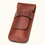 Angled view of a chestnut brown double cigar case made from full-grain leather, engraved with the name "David Bordalo", highlighting stitching and craftsmanship