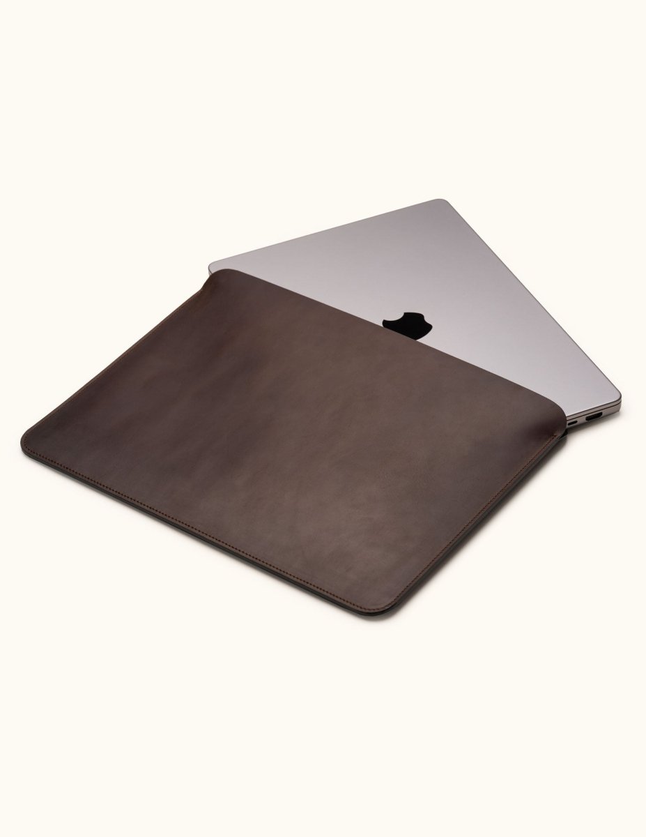 Coffee color full-grain leather sleeve for MacBook Pro 14-inch and 16-inch, shown partially open with laptop inside