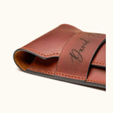 Close-up of a personalized full-grain leather cigar case showing edge finishing, hand-stitching, and engraved name "David Bordalo"
