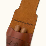 Close-up of a personalized leather double cigar case with inner flap engraving that reads "Happy Birthday My Love", demonstrating hidden custom message option