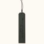 Green leather bookmark engraved with the quote "A new chapter begins..." and a butterfly design labeled "JOSEFINA", featuring a braided black cord at the top