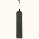 Green leather bookmark engraved with the quote "A new chapter begins..." and a butterfly design labeled "JOSEFINA", featuring a braided black cord at the top