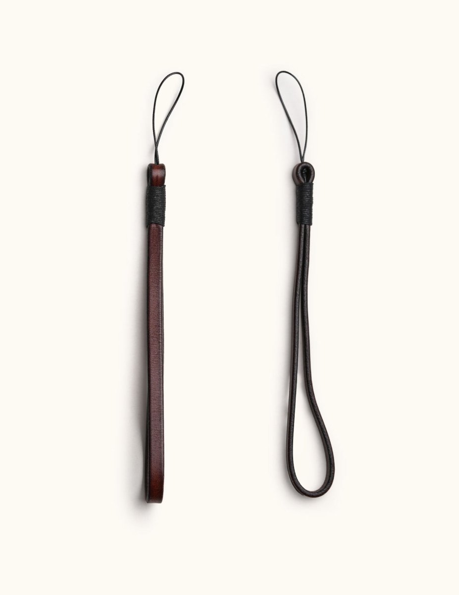 Full-grain leather camera wrist straps in dark brown, featuring different widths and loop styles for secure handheld shooting
