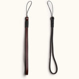 Full-grain leather camera wrist straps in dark brown, featuring different widths and loop styles for secure handheld shooting