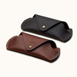 Two handcrafted Crazy Horse leather sunglasses cases in brown and dark brown, with snap buttons and personalized initials