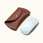 Full-grain leather case shown next to Apple Magic Mouse to illustrate size and fit