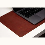 Large personalized leather desk mat used under a laptop, top-grain surface for workspace organization