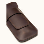 Close-up of a dark brown full-grain leather double cigar case without engraving, highlighting the smooth finish, clean stitching, and minimalist design