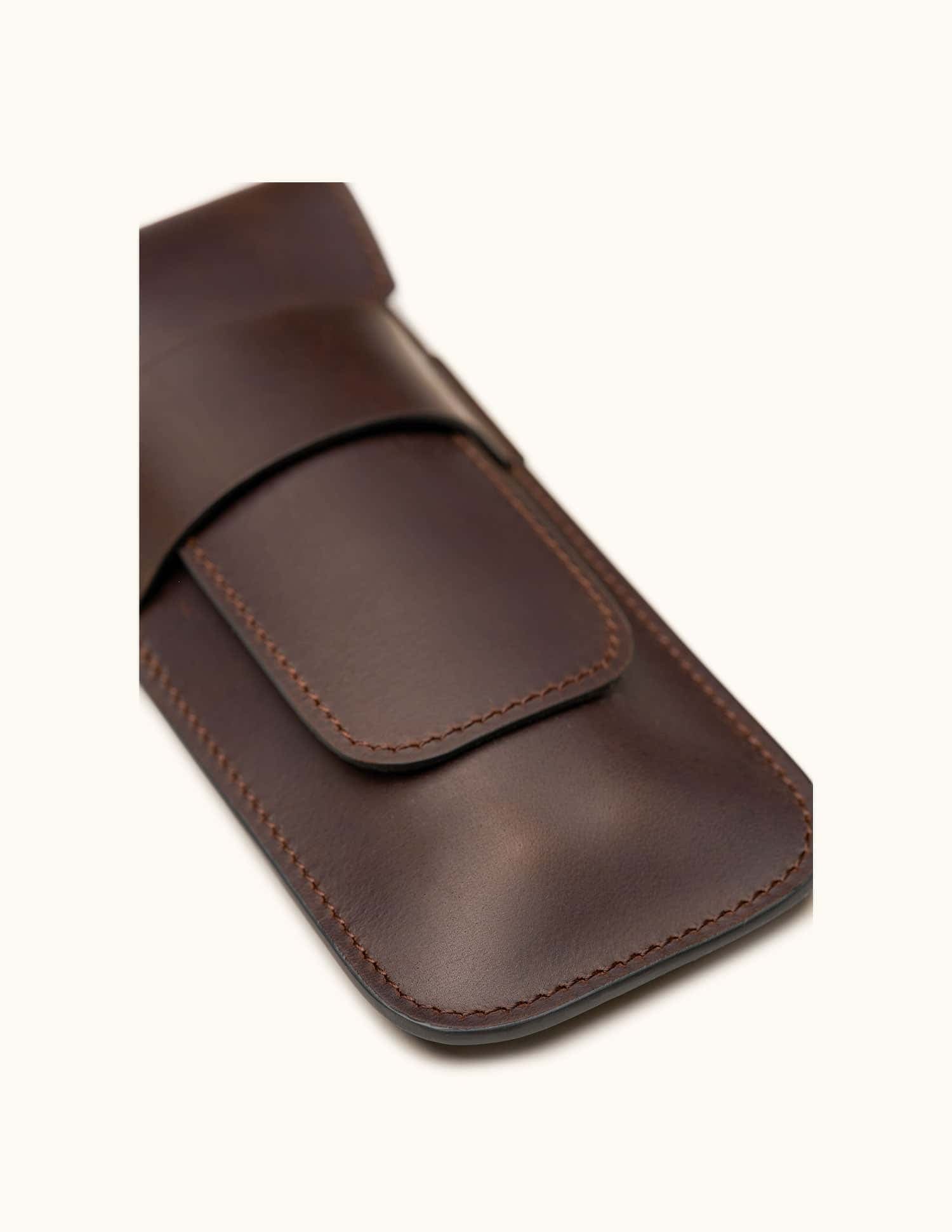 Close-up of a dark brown full-grain leather double cigar case without engraving, highlighting the smooth finish, clean stitching, and minimalist design