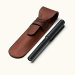 Custom leather fountain pen case with flap closure, shown alongside a matte black fountain pen. Ideal for gifting or everyday protection