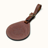 Full-grain leather round luggage tag with compass design and brass buckle strap