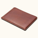 Angled view of vintage brown full-grain leather MacBook sleeve, slim and minimalist desig