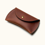 Brown leather travel case for Apple Magic Mouse with snap button closure, angled view