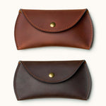 Two color options of full-grain leather Apple Magic Mouse cases shown in tan and dark brown