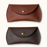 Two color options of full-grain leather Apple Magic Mouse cases shown in tan and dark brown