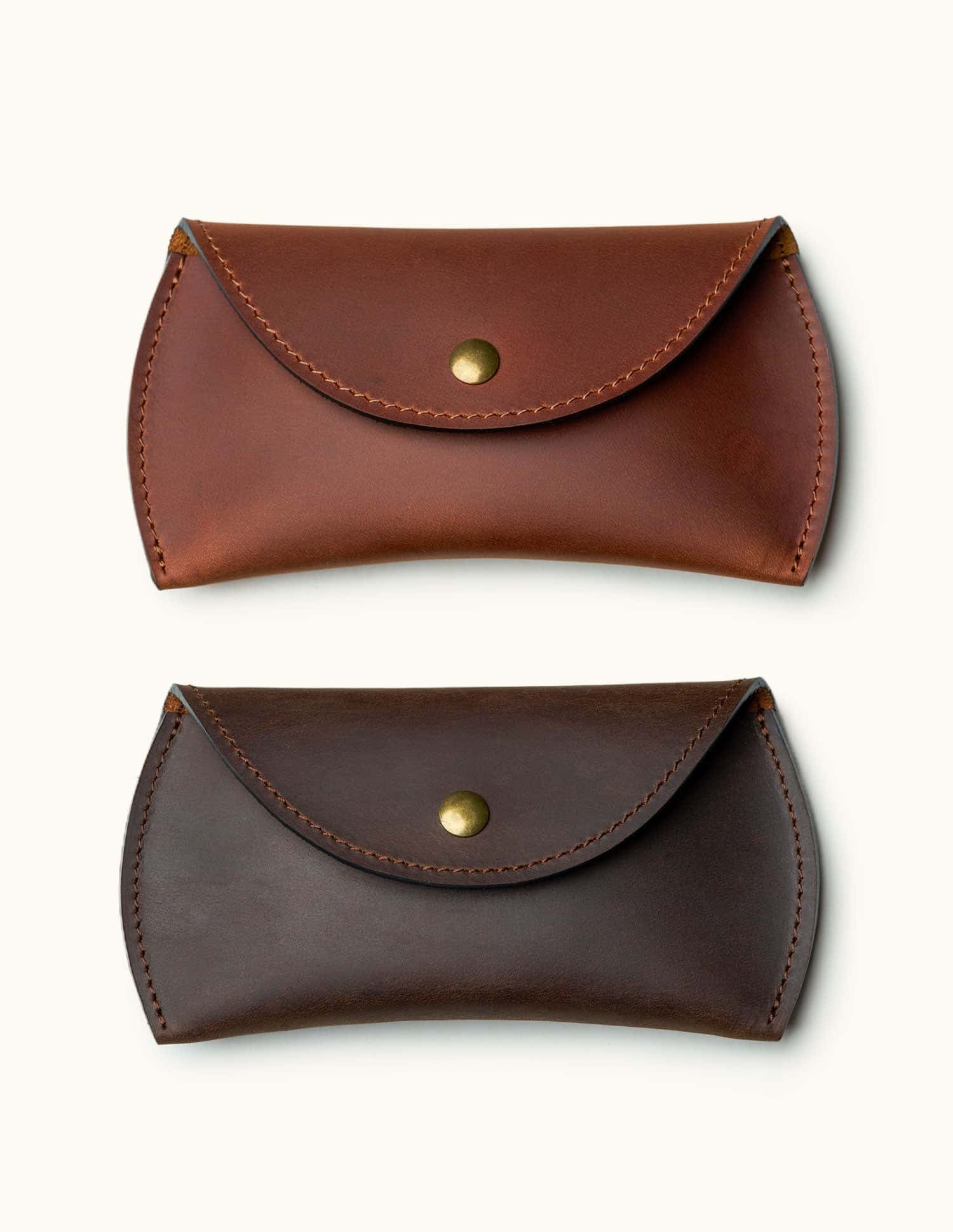 Two color options of full-grain leather Apple Magic Mouse cases shown in tan and dark brown