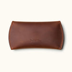 Handmade brown leather sleeve for Apple Magic Mouse, closed with embossed Crafted Man logo