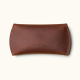 Handmade brown leather sleeve for Apple Magic Mouse, closed with embossed Crafted Man logo