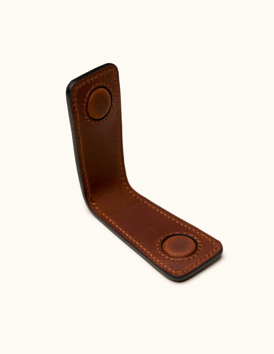 Close-up interior view of brown leather magnetic money clip showing strong built-in magnets and hand-stitched details