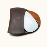Dark brown full-grain leather sleeve with Apple Magic Mouse partially inserted, showing fit and interior textur