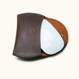 Dark brown full-grain leather sleeve with Apple Magic Mouse partially inserted, showing fit and interior textur