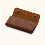 Back view of brown leather SD card holder with snap button closure and hand-stitched detailing