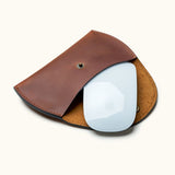 Brown leather case for Apple Magic Mouse, shown open with mouse partially inside