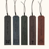 Five personalized leather bookmarks in different colors, each engraved with custom quotes, initials, or dates, with decorative tassel cords on top
