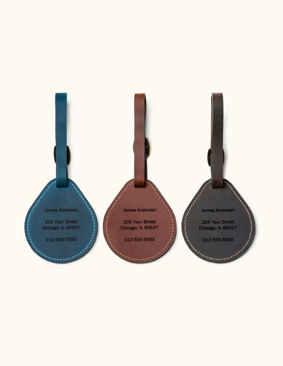 Custom engraved leather luggage tags in blue, brown, and black with name, address, and phone number