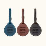 Custom engraved leather luggage tags in blue, brown, and black with name, address, and phone number