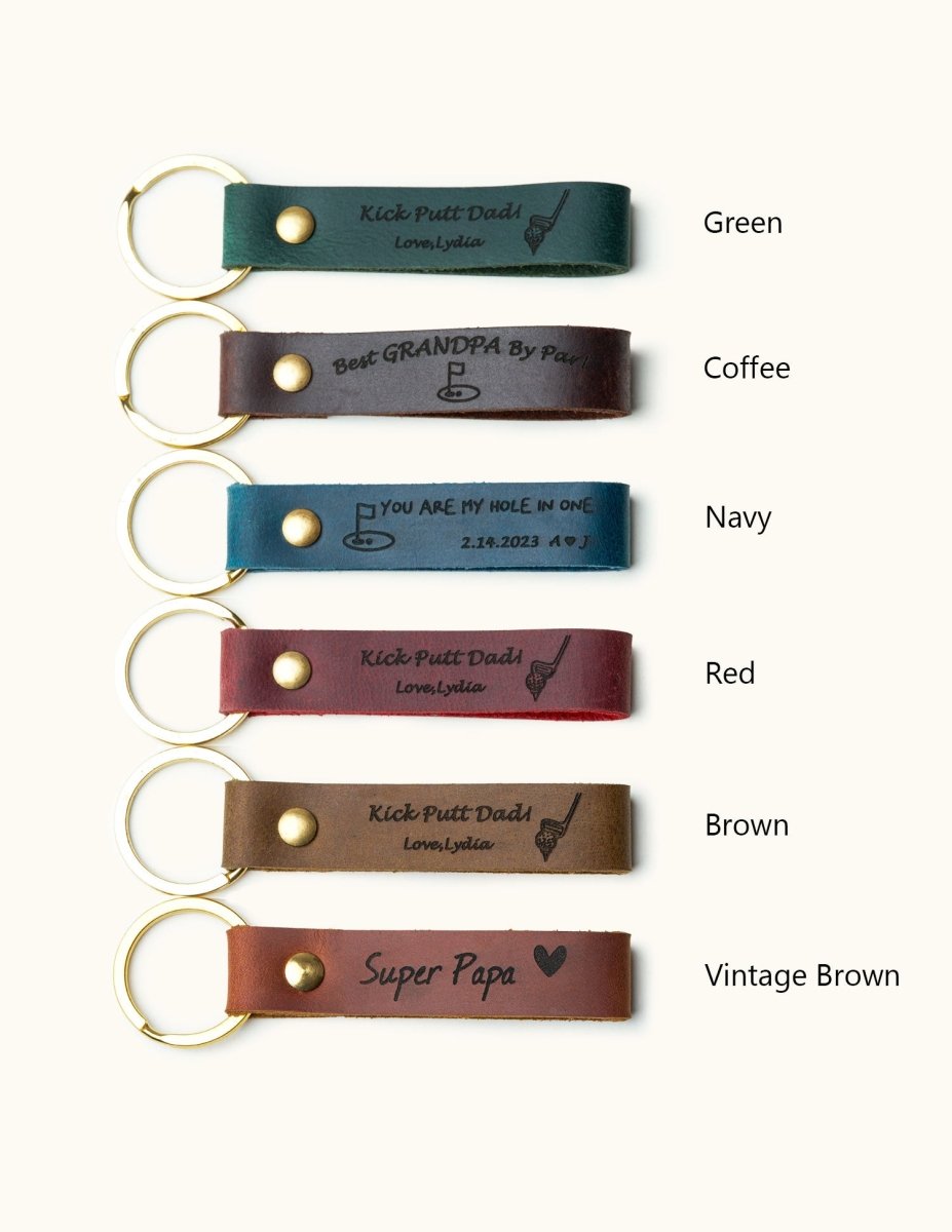 Handmade leather keychains with gold rings engraved with golf-themed messages like “Kick Putt Dad,” “Best Grandpa By Par,” and “You Are My Hole In One,” perfect personalized gifts for golfers, dads, and grandpas.