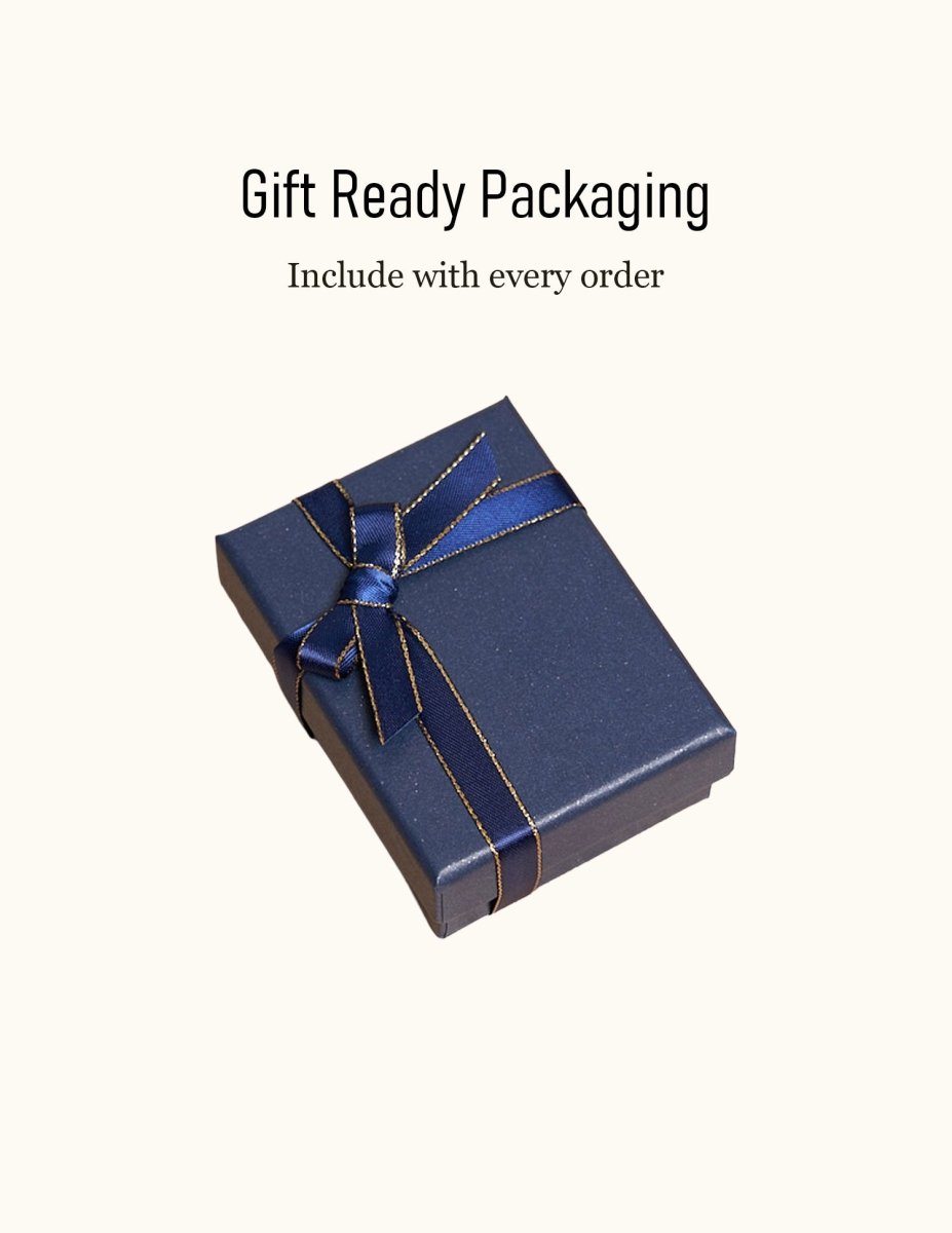 Elegant dark blue gift box with a gold-trimmed ribbon, included with every personalized leather AirPods case order. Perfect presentation for a men's tech gift.