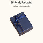 Elegant dark blue gift box with a gold-trimmed ribbon, included with every personalized leather AirPods case order. Perfect presentation for a men's tech gift.