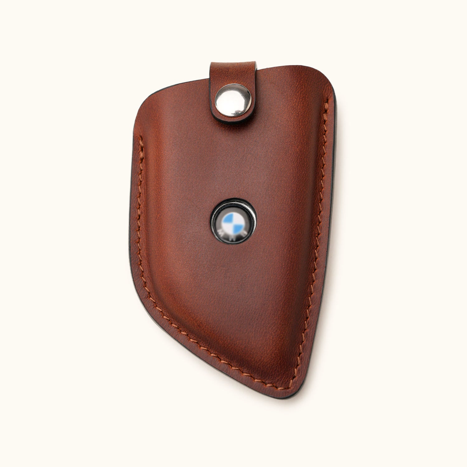 Front view of handcrafted brown leather key fob cover for BMW G Series smart key with logo window and snap closure