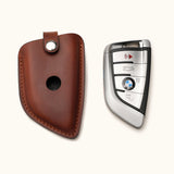 Handcrafted brown leather key fob cover for BMW G Series smart key with snap closure, shown with ke