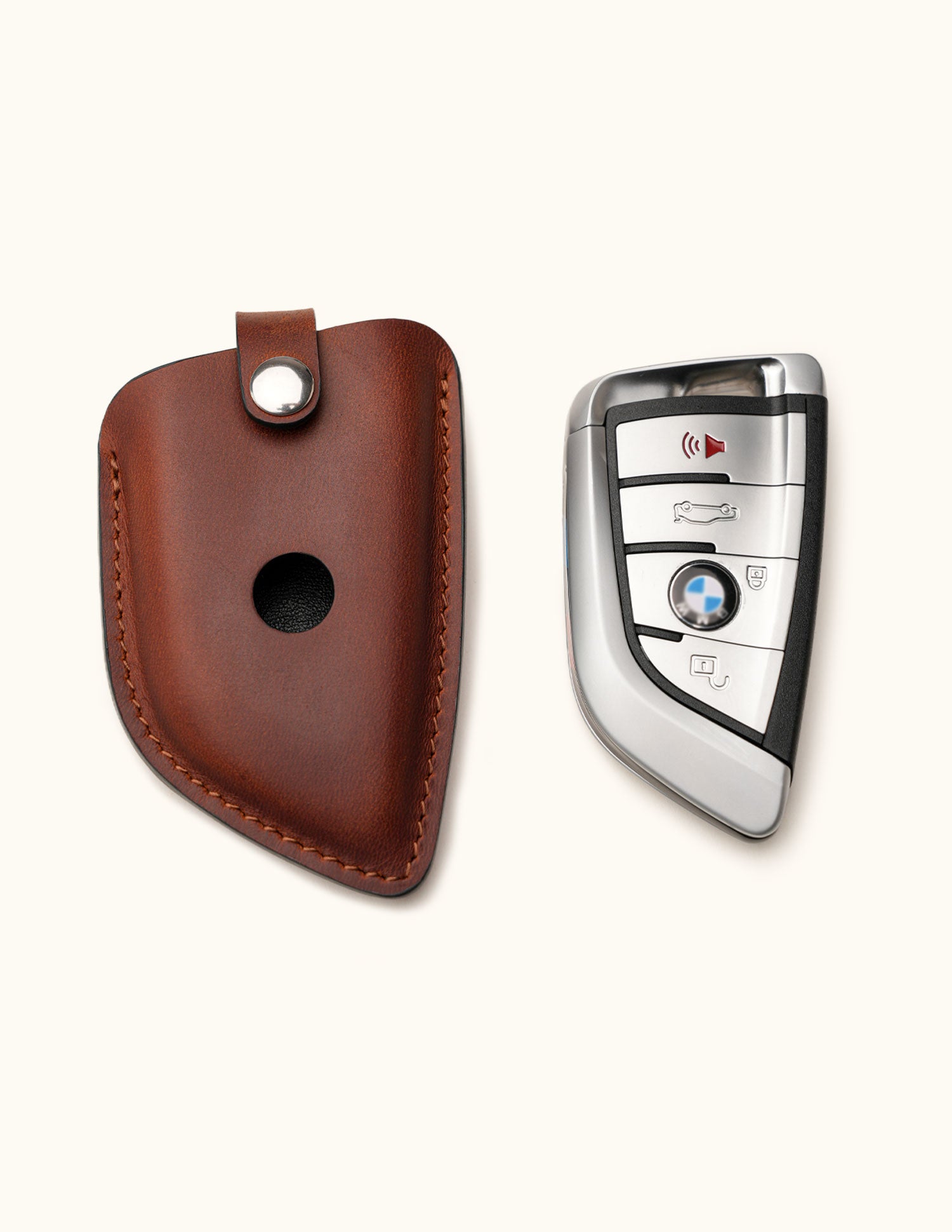 Handcrafted brown leather key fob cover for BMW G Series smart key with snap closure, shown with ke
