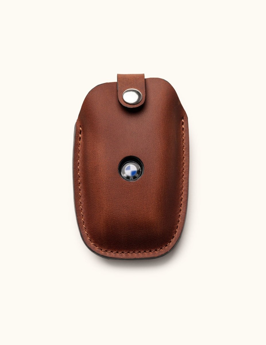 Front view of brown leather key fob cover for BMW car key with snap closure and logo window