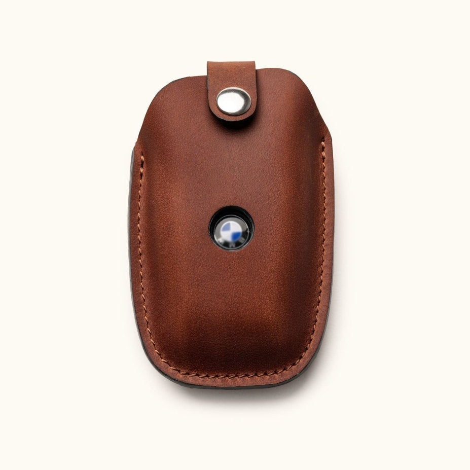 Front view of brown leather key fob cover for BMW car key with snap closure and logo window