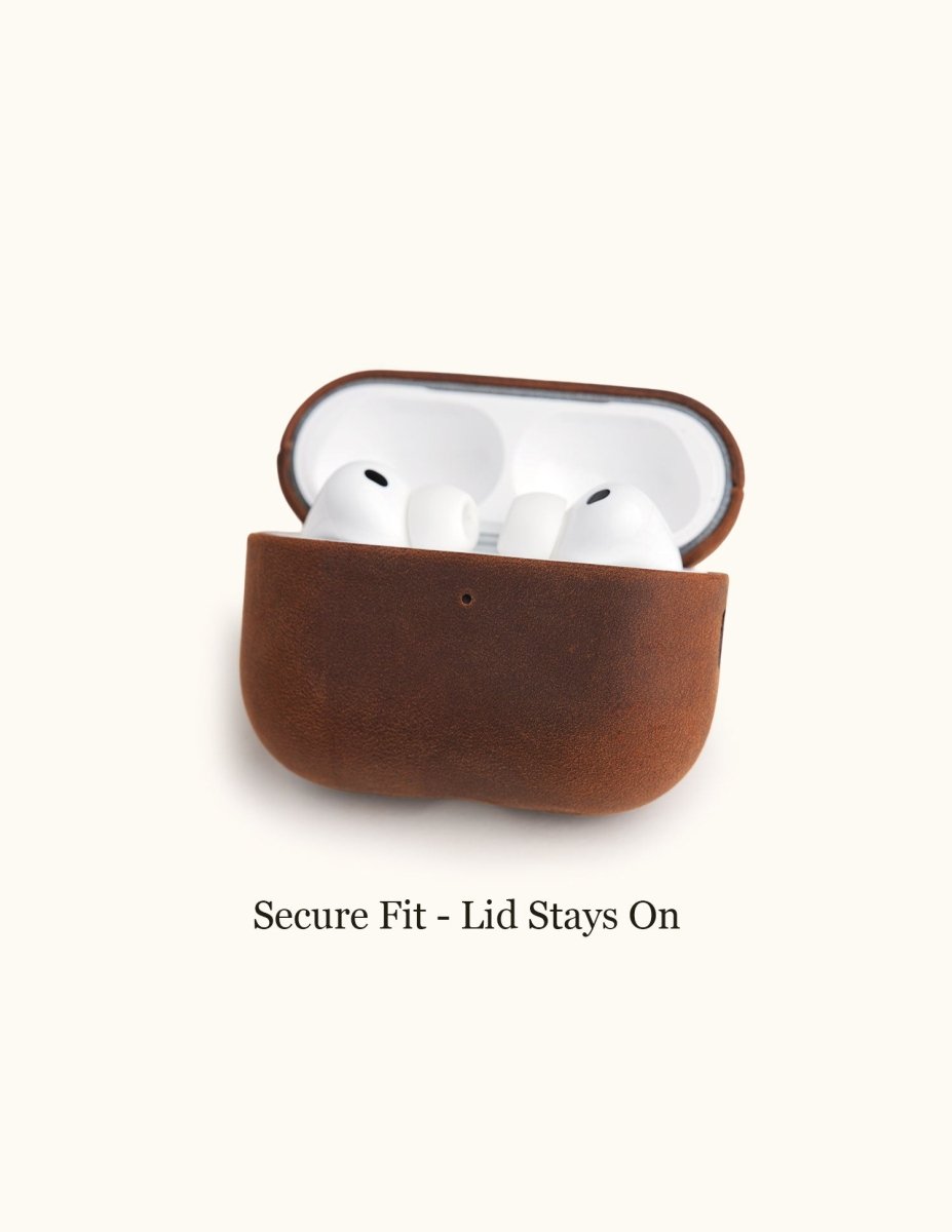 Open view of a vintage brown crazy horse leather AirPods case resting on a white surface. The text "Secure Fit - Lid Stays On" highlights the precision molding that prevents the top leather cover from slipping off during daily use.
