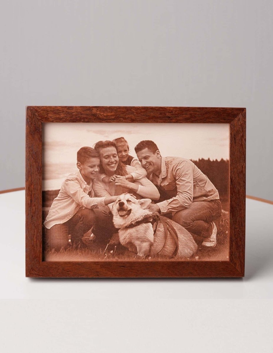 Laser-engraved leather photo of a smiling family and their dog, framed in wood — a personalized keepsake gift for pet lovers and family memories