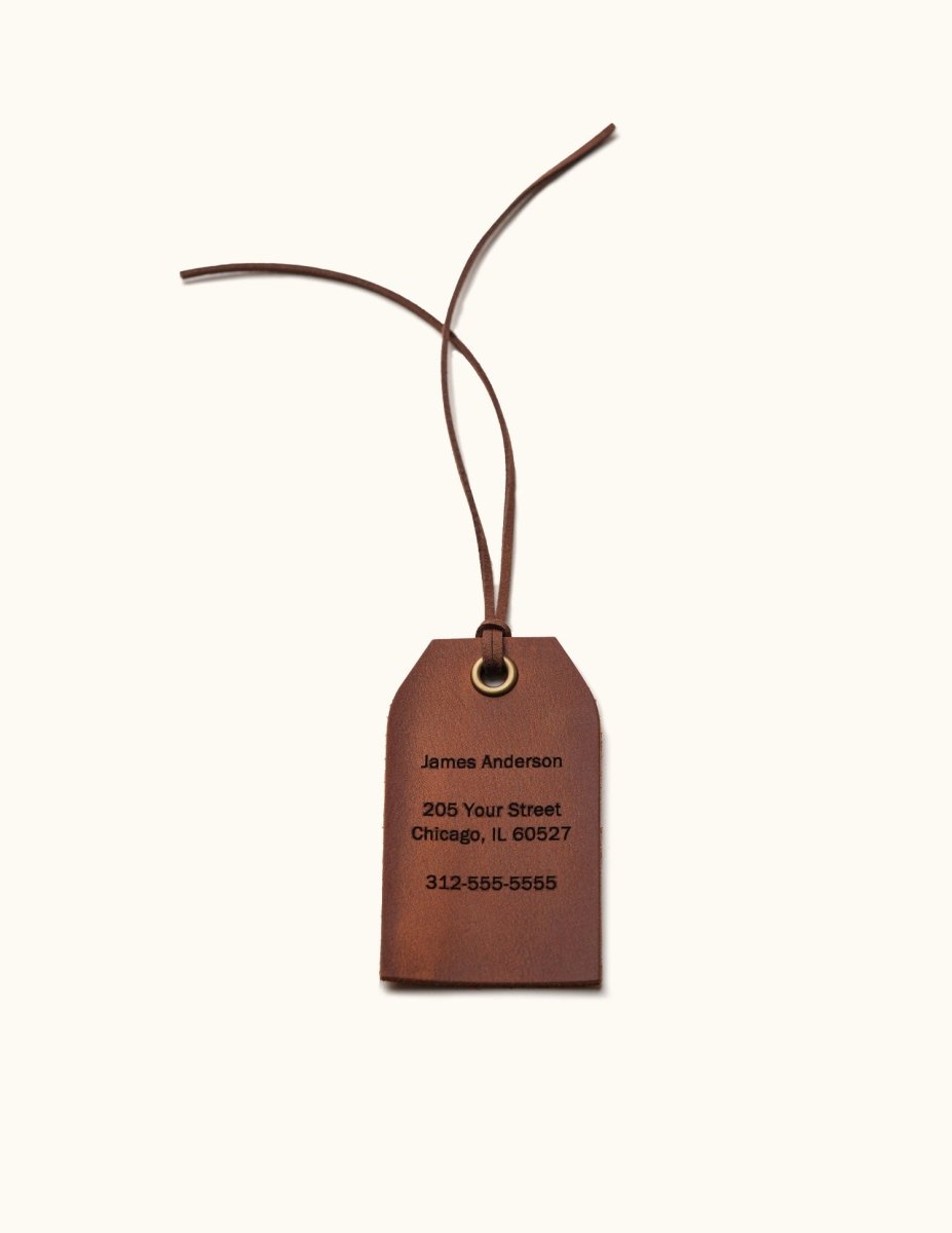 Single personalized leather luggage tag in Vintage Brown with engraved name, address, and phone number, featuring a brass eyelet and leather tie