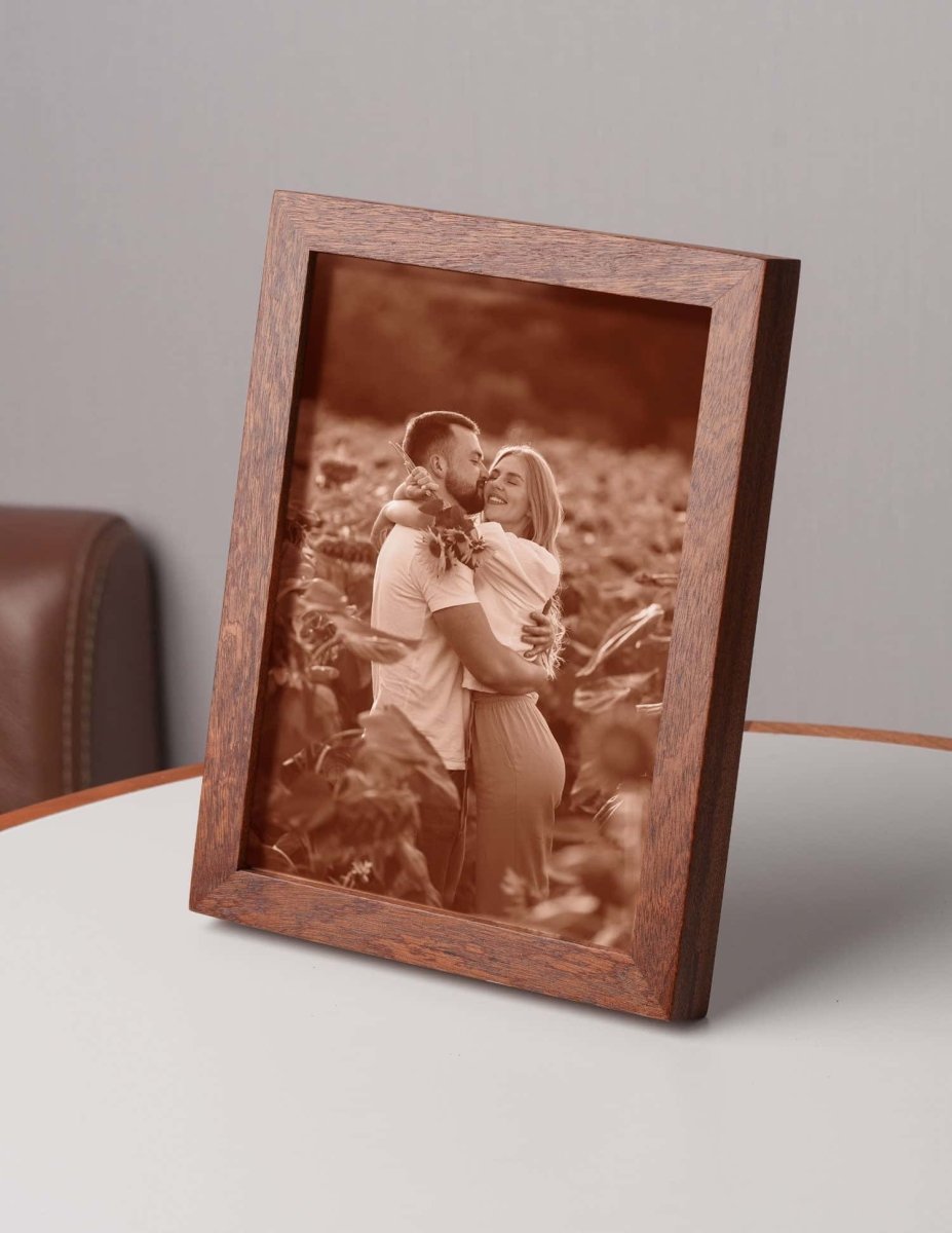 Laser-engraved leather photo of a couple embracing in a field, framed in wood — a personalized romantic gift for anniversaries, weddings, or Valentine’s Day