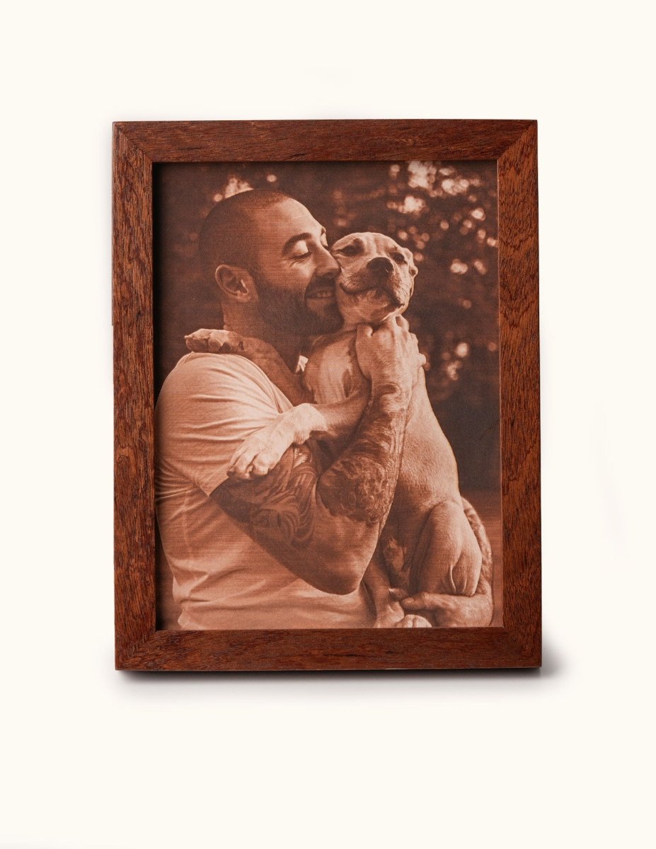 Laser-engraved leather photo of a man hugging his dog, framed in wood — a heartfelt personalized gift for pet lovers and dog dads