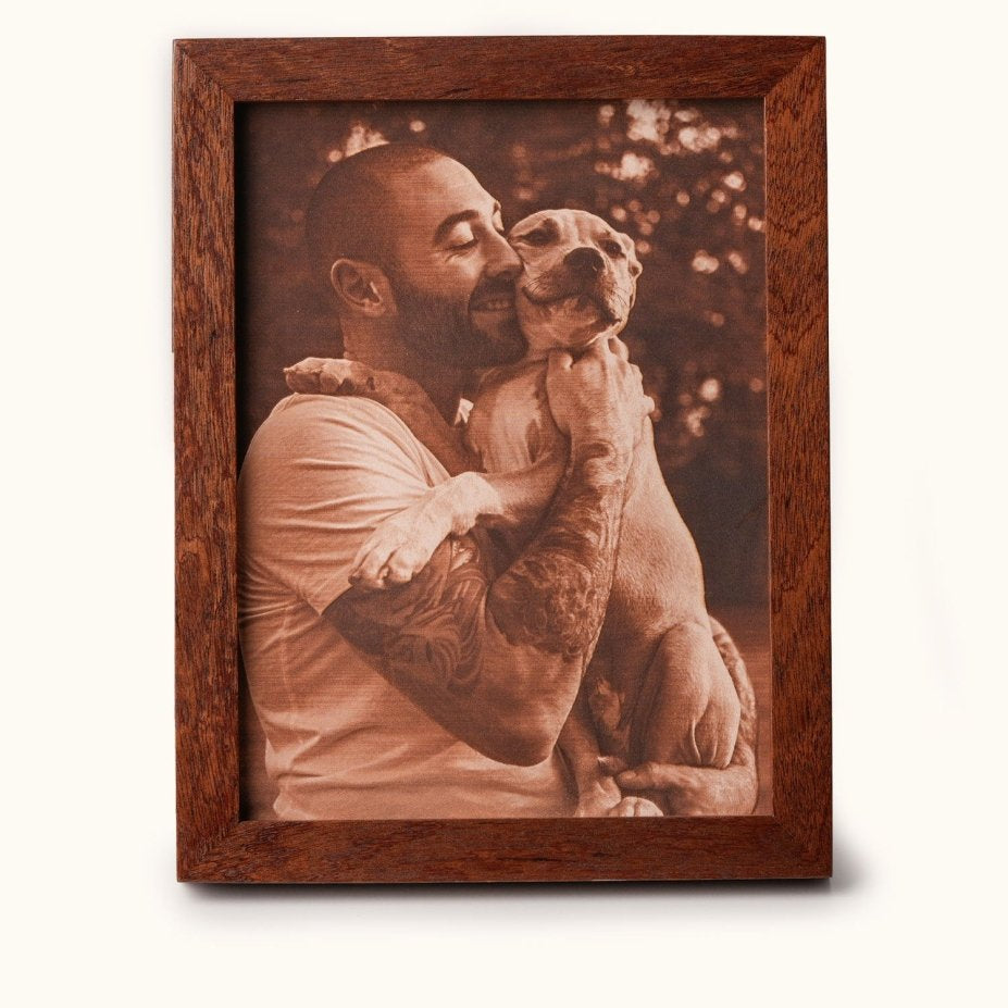 Laser-engraved leather photo of a man hugging his dog, framed in wood — a heartfelt personalized gift for pet lovers and dog dads