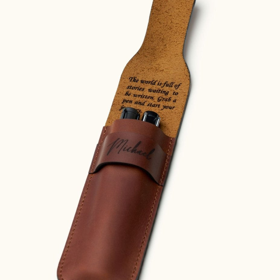 Double pen leather case with custom engraved message on the inner flap. Holds two fountain pens and features name engraving on the front