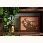 Father’s Day custom leather photo frame featuring a father and daughter, engraved with “Happy Father’s Day to the best dad ever” — displayed on a rustic wooden shelf with plants and deco