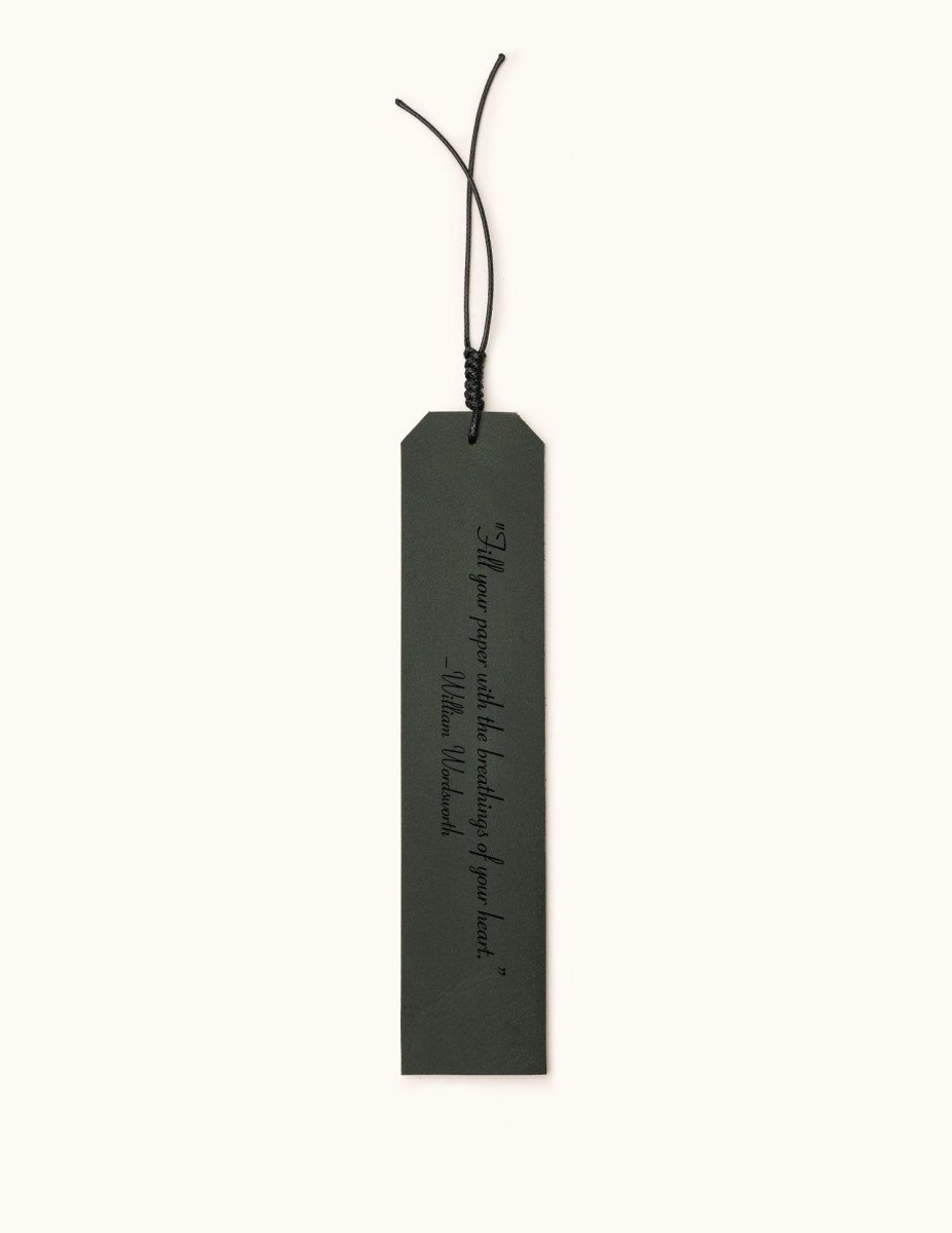 Green leather bookmark engraved with the quote "A new chapter begins..." and a butterfly design labeled "JOSEFINA", featuring a braided black cord at the top