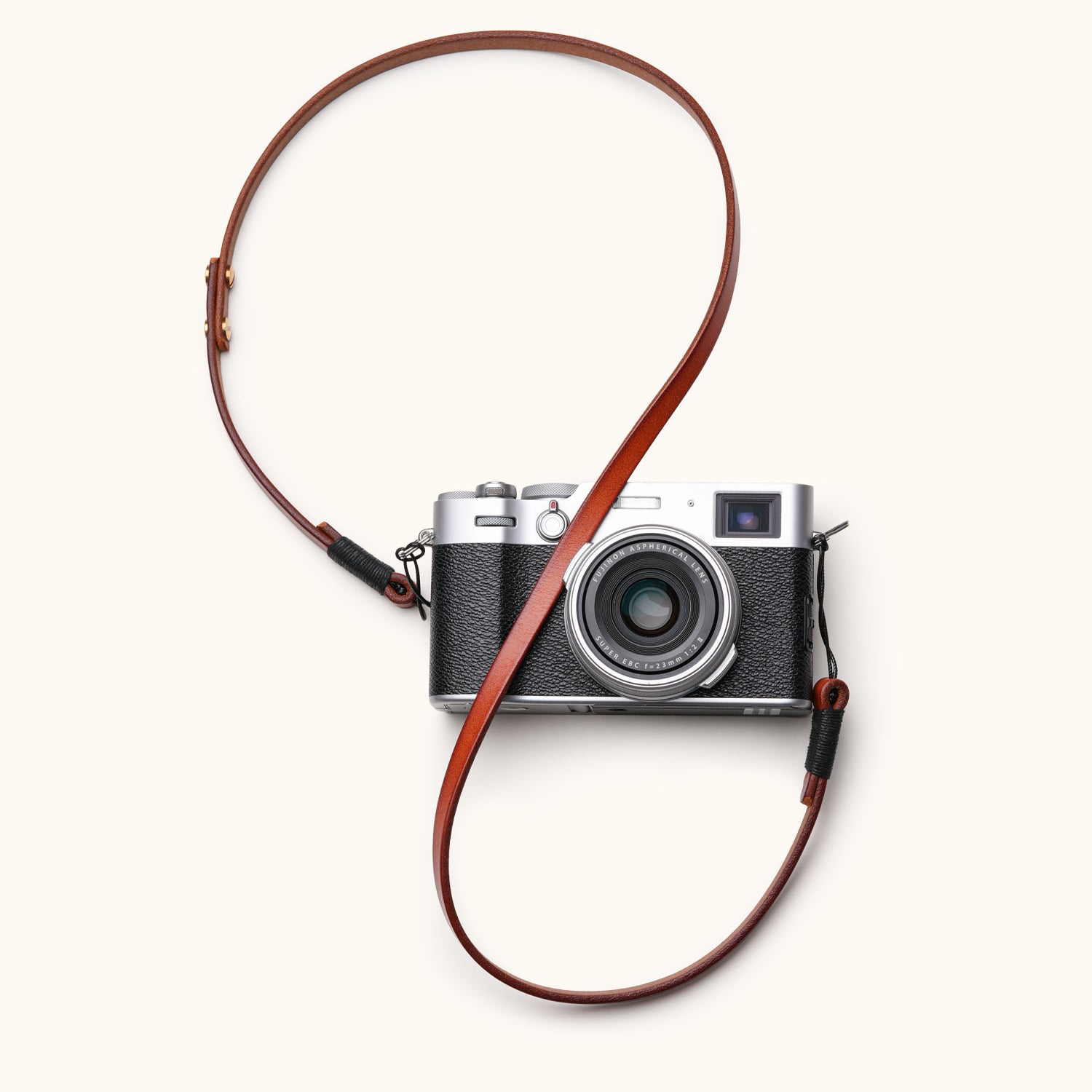 Full-grain handcrafted leather camera strap attached to a vintage-style mirrorless camera, styled in loop