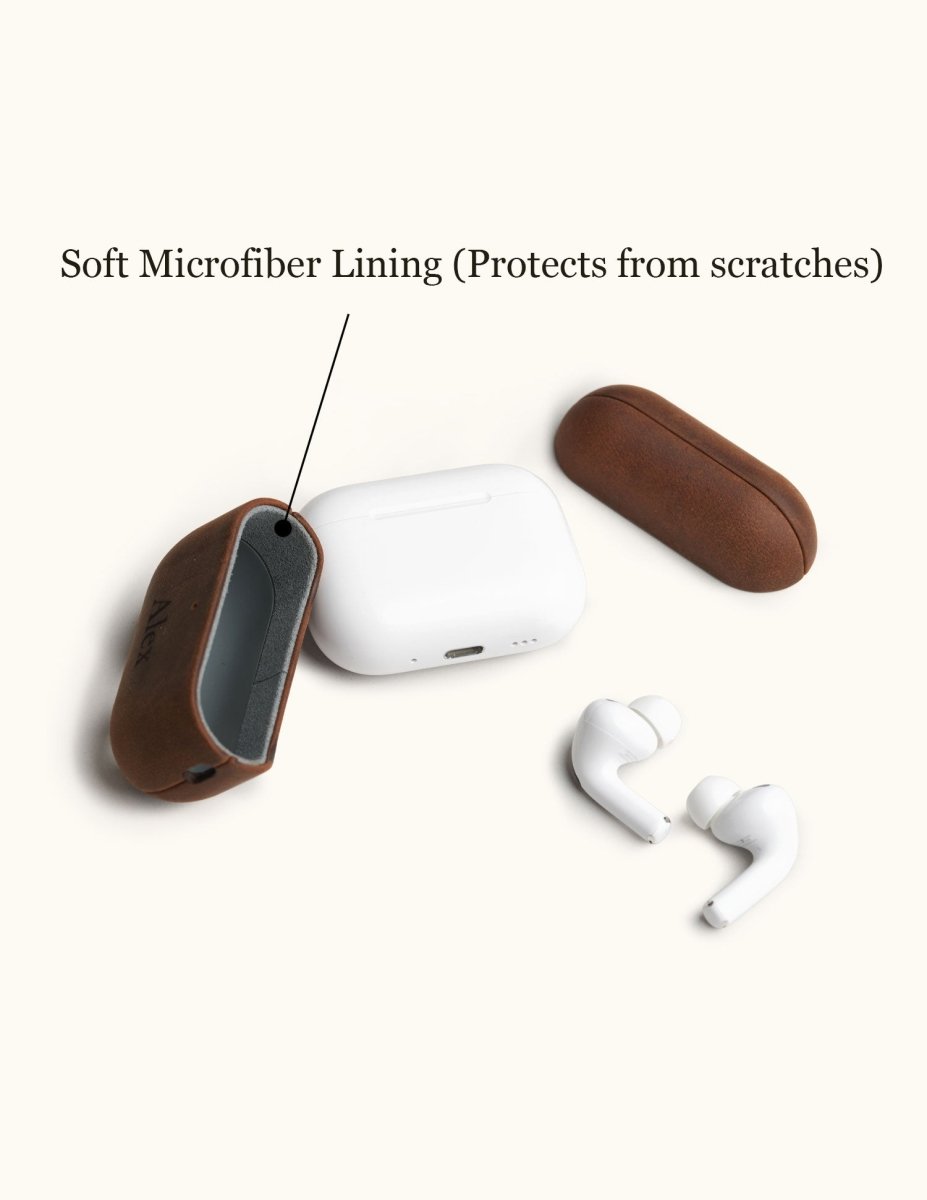 Disassembled brown leather AirPods 4 case showing the soft grey microfiber lining. This interior design protects the white Apple charging box from scratches.