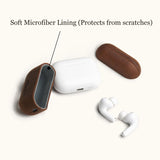 Disassembled brown leather AirPods 4 case showing the soft grey microfiber lining. This interior design protects the white Apple charging box from scratches.